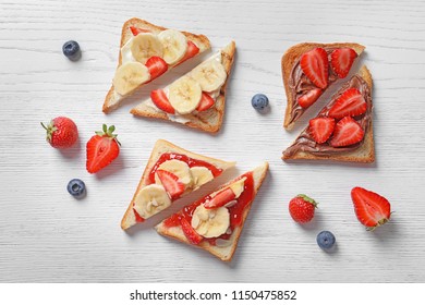 Tasty Toast Bread With Banana And Strawberry On Light Background