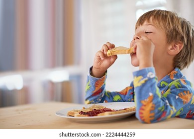 Tasty toast. A cute little boy eating breakfast. - Powered by Shutterstock