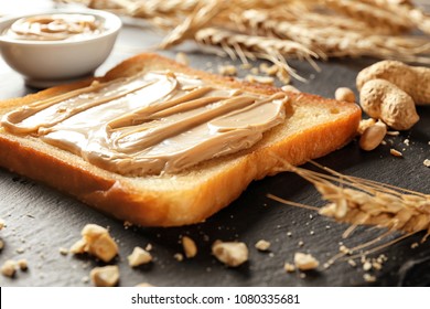 Tasty Toast With Peanut Butter On Slate Plate, Closeup