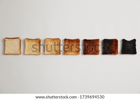 Similar – Image, Stock Photo Toasted toast bread in toaster on pink background