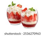 Tasty trifle dessert. Sponge cake, strawberries, jam and whipped cream in glasses isolated on white