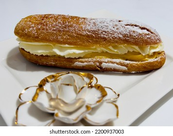 Tasty Vanilla Eclair On A Plate