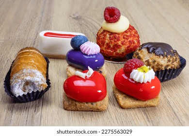 tasty various colorful pastries on wooden table - Shutterstock ID 2275563029