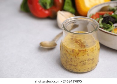 Tasty vinegar based sauce (Vinaigrette) in jar on light table, closeup. Space for text - Powered by Shutterstock