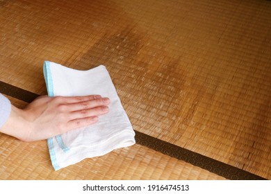 A tatami mat with a stain. Floor of a Japanese house. Wiping with a rag.