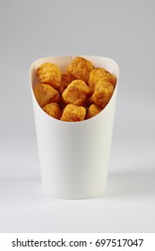 Tater Tots In Carton On White