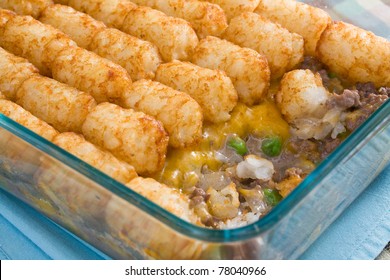 Tater Tots Casserole - Casserole Made Of Tater Tots, Cheddar Cheese, Ground Beef, Peas, And Onions.