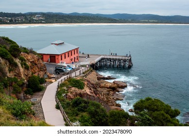 Tathra, NSW Australia - 23 February 2021: The historic Tathra Wharf, built in 1862,  is the only deep sea timber wharf on the South coast of Australia and is popular among tourists and photographers.