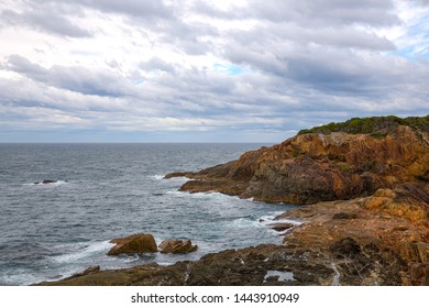 Tathra Wharf Lookout with Ocean Cliffs and rocks on the Far South Coast of NSW, Australia. Sea Coastline with foam and waves and clouds in the sky.