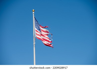 Tattered American Flag Seen On Pole