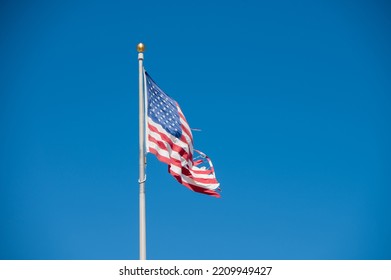 Tattered Looking American Flag On Pole