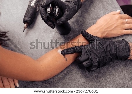 Image, Stock Photo Anonymous tattoo artist applying transfer paper on client’s back