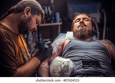 Tattoo Artist Doing Tattoo In Tattoo Parlor