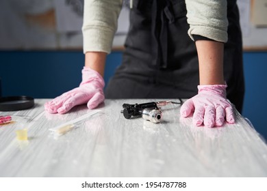 Tattoo Artist Wearing Protective Pink Medical Gloves Standing At The Table