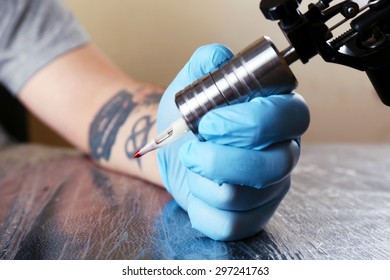Tattoo artist at work close up - Shutterstock ID 297241763