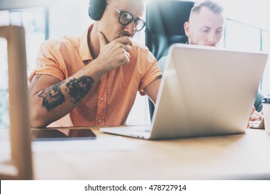 Tattoo Artist Working Wood Table Laptop Modern Interior Design Loft.Coworkers Work Office Studio.Two Hipsters Use Contemporary Notebook Digital Tablet New Project.Blurred Background. Business Startup