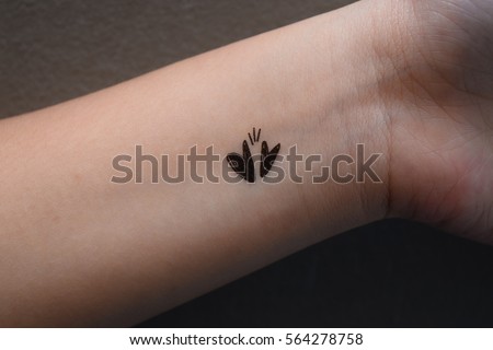 Tattoo designs two hearts on the woman's wrist.