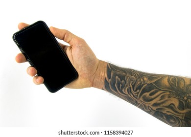 Tattoo and hand holding phone isolated in white background