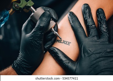 Tattoo. Hands Of A Tattoo Artist Up Close