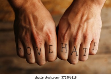 Tattoo inscriptions male fingers