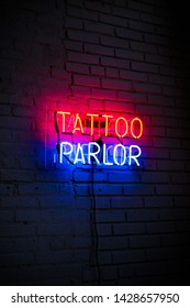 Tattoo Parlor Neon Sign On Brick Wall