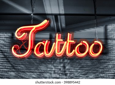 Tattoo Sign, Neon Sign In A Tattoo Shop Window. Red Information Sign, View From Outside Into A Store. 