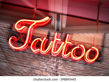 Tattoo Sign, Neon Sign In A Tattoo Shop Window. Red Information Sign, View From Outside Into A Store. 