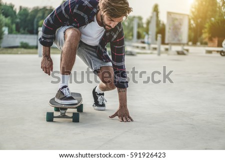 Similar – Image, Stock Photo Young bearded skater performing trick in skatepark