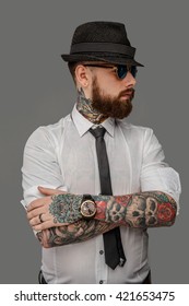 Tattooed Bearded Man In White Shirt Isolated On Grey Background.