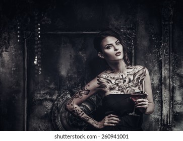 Tattooed beautiful woman in old spooky interior
