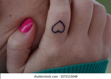 tattooed finger heart