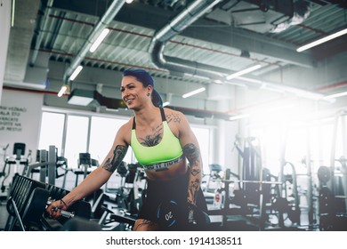 Tattooed Woman Workout In Gym