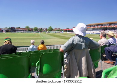 Taunton England. The County Cricket Ground With Spectators Watching A Game In Progress. View Of Cricket Pitch And The Sir Ian Botham Grandstand. Sunny With Blue Sky.