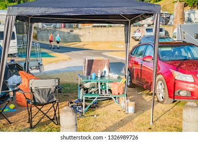 TAURANGA  NEW ZEALAND - FEBRUARY 14; Messy Family Campsite With Chairs Table And Other Things February 14 2019 Tauranga New Zealand