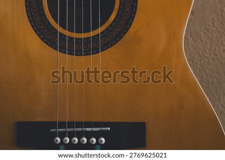 Taut Acoustic Strings Above A Patterned Sound Hole