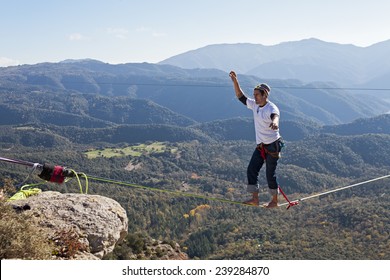 TAVERTET - NOVEMBER 16: Man doing highline in Tavertet, Spain on November 16, 2014. Highline is a balance sport that consists walking through a rope clamped between two points and great height below.