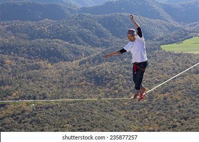 TAVERTET - NOVEMBER 16: Man playing highline in Tavertet, Spain on November 16, 2014. Highline consists walking through a rope clamped between two points and great height below.