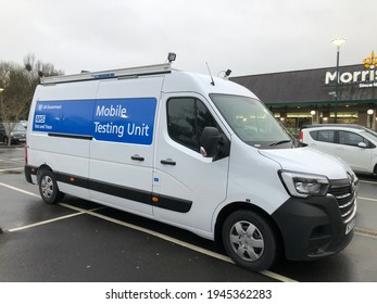 Tavistock England March 2021. Covid-19 Mobile Testing Unit In A White Van With NHS And Description On Side Panel. White Writing On Blue Background.