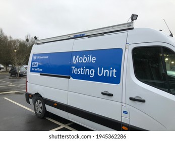 Tavistock England March 2021. Covid-19 Mobile Testing Unit In A White Van With NHS And Description On Side Panel. White Writing On Blue Background.