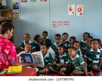 Tawake Village, Fiji - February 17 2017: Male Peace Corps Volunteer Teacher Teaching Fijian Children English Class In Small Village School