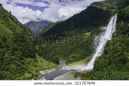 Tawang, Arunachal Pradesh, India. Waterfalls flow into the Kameng river in a deep valley surrounded by mountains of the Himalayas near Tawang, Arunachal Pradesh, India.