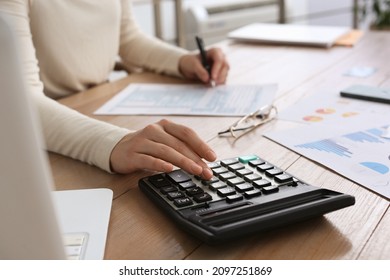 Tax Accountant With Calculator Working At Wooden Table, Closeup