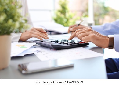 Tax accountants working with documents at table