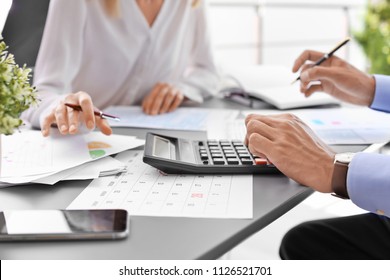 Tax accountants working with documents at table