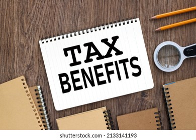 TAX BENEFITS, Notepad Page On Wooden Background. Text On White Paper