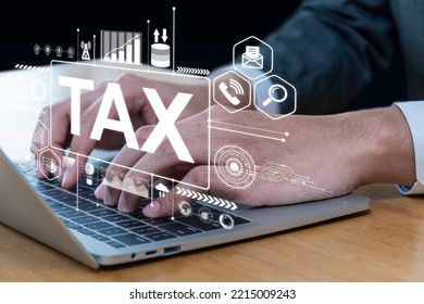 TAX. business hand using laptop computer with virtual TAX graphic icon on desk at home, document management system, digital marketing, tax online, business finance, internet network technology concept