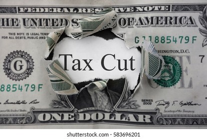 Tax Cut Text On A Scrap Of Paper Within A Torn Dollar Bill                               