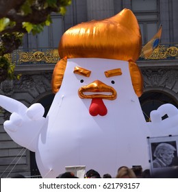 Tax Day March, Civic Center, San Francisco. April 15, 2017.  Giant inflatable chicken with a Donald Trump hairdo.