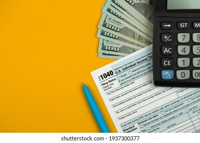 Tax Day And Time To Pay Taxes Concnept, 1040 Income And Return Form With Money And Calculator On The Office Desk Or Table