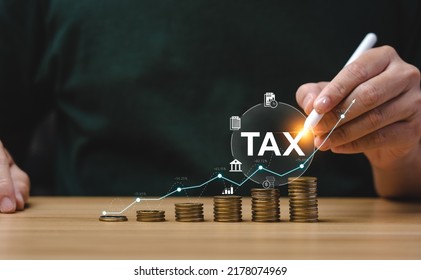 Tax deduction planning concept. Expenses, account, VAT, income tax, and property tax, pay tax. Businessman's hand and pile of coins on the table.